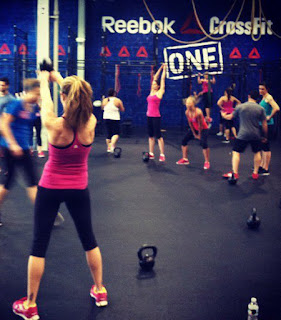 Heather Hart and other women swing kettlebells at the Reebok Crossfit ONE facility during a workout
