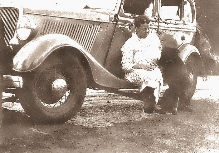 A poignant photo.  Ruth Warren with presumably her pup, & shot up car.