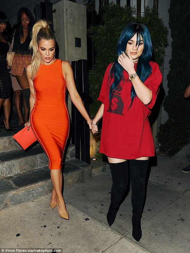 Khoe Kardashian flaunts curvaceous figure in orange ensemble
