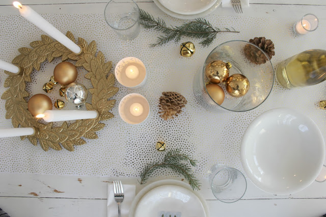 White gold and green Christmas decorated tablescape on white farmhouse table