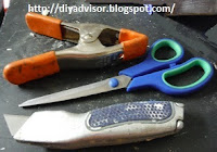 The tools are spring clamp, scissors and razor knife