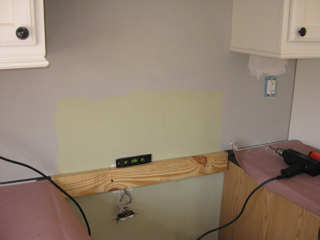 installing a temporarily support during backsplash installation