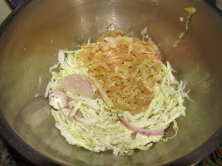 Mixing the raw and stir fried vegetables for homemade shawarma