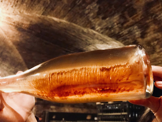 A Contratto sparkling wine bottle with lees still in the bottle, mid-riddling process. Photo credit: Nicole Ruiz Hudson