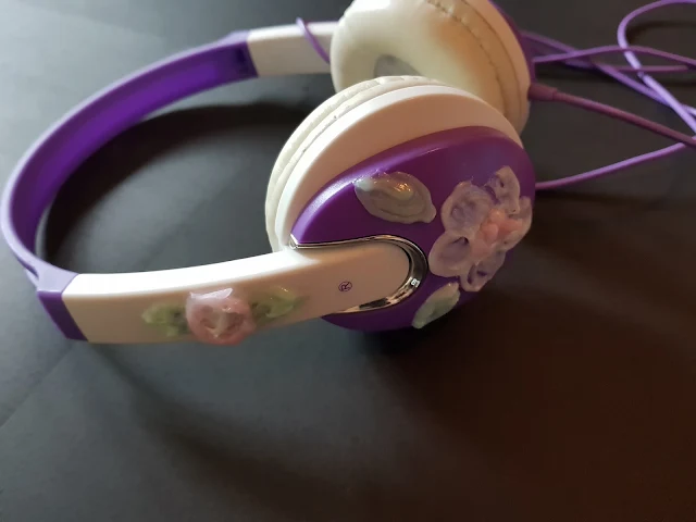 Purple and white headphones decorated with flowers created using Gel-a-Peel