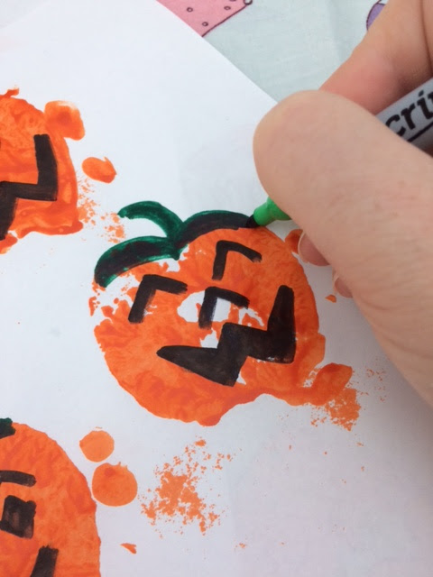 Face and storks being drawn on the pumpkins