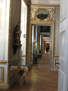 Hallway cutting through a row of rooms