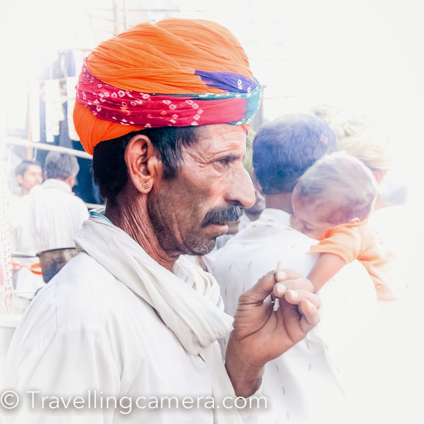 7 years back when I started learning and practicing Photography seriously, I planned to visit Pushkar Camel Fair. It's a very good place to go and shoot diverse things - people, action, games, camels, colorful dresses, dance performances, trades, mela, temples, lake and lot more. It's definitely worth exploring once and camera is a not must :). This Photo Journey shares 7 years old photographs from Pushkar, along with some of the experiences you can expect during Pushkar Camel Fair. My mentor told me about the fair, although I was not sure if I would be able to take out that weekend for Pushkar visit. On Friday evening, I realized that I don't have anything pending for weekend. So went home, packed my bag and reached ISBT Delhi. I got a comfortable bus from Delhi bus-stand to Ajmer. It was a good ride from Delhi to Ajmer in Rajasthan Road Trasport bus. Bus dropped me at Ajmer before 5am. Again took a local bus and reached Pushkar town. It was very cold in the morning, so took out my jacket and started searching for a place to stay & keep my stuff safe for next two days. It's recommended to do advance booking if you want to stay in a good hotel, otherwise smaller options can be explored when you are there. But I am talking about it from my 7 years old experience :)I got a nice hotel along the lake-side. There are many havelis around the lake which have been converted into Hotels. During the fair, these hotels have special arrangements on roof-top to party and enjoy special evenings with friends. Above photograph is shot from the roof-top of my hotel. During my stay, I realized that many of these hotels also have dormitories. Lot of groups from Israel & other foriegn countries prefer to stay together and try to keep the cost low. That's how they can travel more to explore different parts of our country.  There is a 5-10 minutes walk from Bramha temple to the grounds where Camel Fair happens. There is a stadium in Pushkar which is mainly used for various games and competitions, in which camels, horses and elephants participate. Check out this video showcasing horse dance competition - This lake in Pushkar is huge and has religious importance. You can notice lot of religious activities happening around the ghats. Lot of pandits may approach you to do different types of worships, so be very aware of all that. Don't indulge into any discussions with these guys, because I have seen these folks shouting on innocent folks roaming around and make them do different things without their wish. They create pressure on people by different means and at times, tourists feel helpless. It's sad to see such activities happening at such a beautiful place, because many times foreigners take back those bad experiences with themI am sure that you must be wondering about camels in this Photo Journey. I have lost most of my Pushkar shots in a HDD crash and these are picked from other locations & friends. So at Pushkar Camel Fair, you can expect lot of camels all around. Header photograph of this blog is also one of the shot from Pushkar.The fair happens every year in the month of October, so if you feel like visiting Pushkar Camel Fair this year, just check out the schedule and plan your visit. It's a week long fair, so you may want to check the schedule and decide appropriate days to visit Pushkar town in Rajasthan.Food at Pushkar Camel Fair is another special experience. It gets really hard to find Indian food in Pushkar, except some of the dhabas on fair ground. Most of the restaurants in main town serve non-Indian cuisine. They of-course charge higher but still reasonable :).  During the stay, make it a point to talk to local folks and try to undertsnad more about the Camel trading and various other activities of this fair. You would be surprised to know about some facts around pricing of camels, types of camels and how people bring them here etcPushkar is also a great place to capture some colorful portraits from Rajasthan State of India. I am sure that many of you can click far better portraits than what is shared on this blog.I am also trying to figure out the possibilities to visit Pushkar Camel Fair this year. Keep me informed if any of you want to come along. Comment back.. We can connect and plan together.