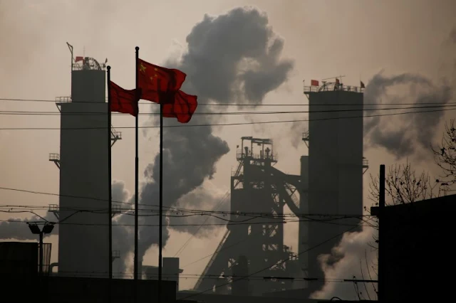 Image Attribute:  Chinese national flags are flying near a steel factory in Wu'an, Hebei province, China, February 23, 2017. Picture taken February 23, 2017.  REUTERS/Thomas Peter