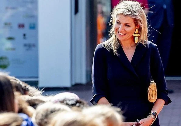 Queen Maxima wore Natan Crepe Jumpsuit, Natan gold earrings, and she carried Natan clutch bag for More music in the classroom' meeting