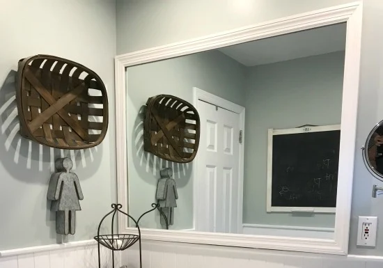 Mirror with a frame and tobacco basket