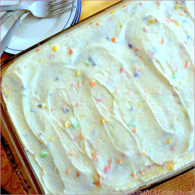 Sweet and Tart Cake, a French Vanilla cake with a gooey sweet and tart surprise. | Recipe developed by www.BakingInATornado.com | #recipe #cake