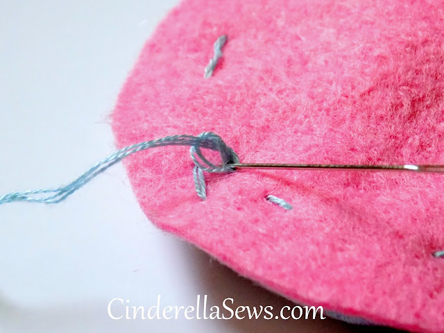 This DIY Toddler toy gift is the perfect beginner hand-sewing tutorial. Make a simple stuffed felt disc embellished with sewn yo-yos! #sewing #crafts #beginnersewing #handsewing #embroidery #diygifts #yoyo 