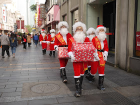 Santas walking down the Wuma Pedestrian Street in Wenzhou