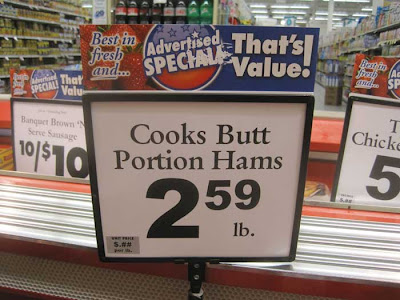 Sign in a meat cooler reading Cooks Butt / Portion Hams