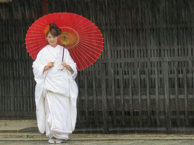 Woman with umbrella dressed in traditional clothing in Kyoto Japan