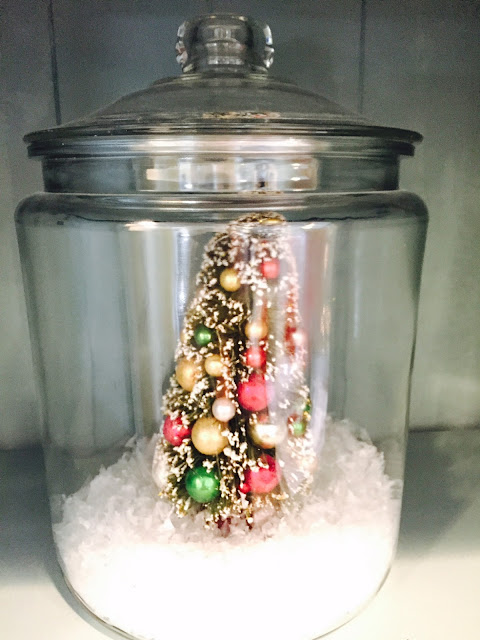Bottle Brush tree in glass jar with snow