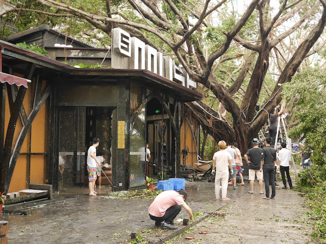 people cleaning up debris from Typhoon Hato at the Bay Bar Street in Zhuhai