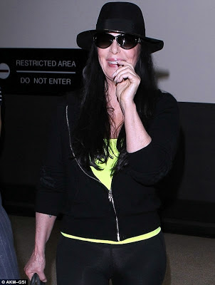 Cher grinning whilst passing through LAX airport