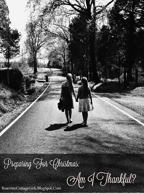 Am I thankful in text Photo of two girls walking down a narrow country road with large trees on the sides of the road. The girls are barefoot and it is just after a rain shower. They are holding hands.