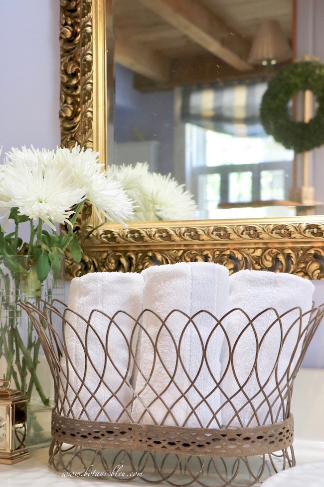 french wire basket with towels in master bathroom adds french country style