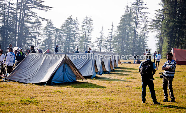 During recent trip in Himalayas, we also visited a small village called Ghda Kuffer with amazing natural beauty. We reached this place after crossing various hills, raw roads and dense forests, but all was worth... Let's have a quick Photo Journey of this place in Shimla region of Himachal Pradesh...This was our camping ground. It was actually a natural ground in the middle of dense forest with high cedars and pine trees. Although it was just beginning of October, but it was too cold out there. Weather made our experience more interesting :)Tents were installed all over Ghada Kuffer. This place was not close to the village but very approachable. There are 3-4 shops in the village for regular stuff. It was around 10 minutes walk to these shops and a beautiful water pond in the middle of Ghada Kuffer Market.As we start moving towards Ghada Kuffer village or market, the camp ground looked more beautiful. It was a climb from camping ground to Ghada Kuffer Market, although not very steep. For some of us it was easy and few of u were not very comfortable in taking short-cuts, so a dedicated road was also there which takes 10 minutes extra...Ghada Kuffer resident with typical Himachali Cap. Usually this cap can be seen in upper Himachal region, but at some places natural flowers are also added on top of it. And it's really surprising that flowers looks almost fresh all the time, unless cap is kept under pressure.A water pond near Ghada Kuffer Market... There are Various houses around this pond and folks in the village are mainly dependent on agriculture and Apple business. Although not everyone has Apple business.There are lot of such beautiful places in Hills of Himachal Pradesh and state of India, but least explored. Many time Himachal Tourism visited this place for analyzing the scope of tourism, but nothing happened till. This is what villagers told us.In past some of the folks also constructed their houses in a way that later, one portion can be converted into Guest-house under new home-stay scheme by Himachal Pradesh Tourism department.Kids following the lines...The very good part about villages in Himachal is about their thoughts around education. It's very hard to locate any child who is not going to schools and most of them do metric at least. Himachal Pradesh is one of the top 3 states in India, when we talk about Literacy.A view of hills around Ghada Kuffer Village, although this photograph is clicked when we left the village and moved towards Shilaroo.With this, PHOTO JOURNEY to Ghada Kuffer ended and hope to visit more such unexplored places in different states India and share on this blog !!! 