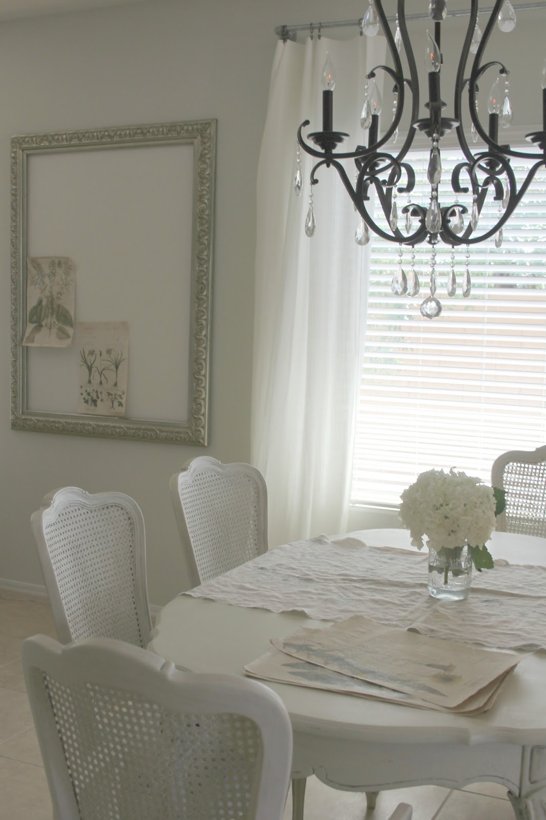 Shabby chic white cane back dining chairs and table by Hello Lovely Studio
