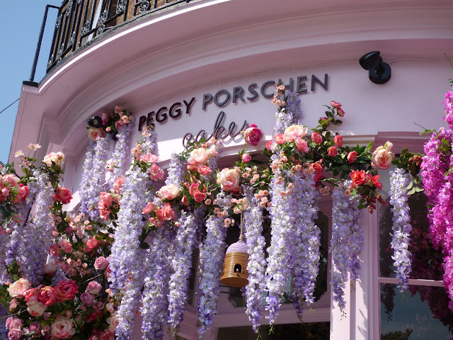 Flower arch and floral display outside Peggy Porschen cafe, London, for free flower festival Belgravia in Bloom 2018