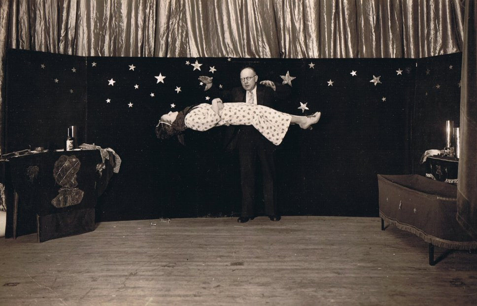 A magician levitating a woman on the stage, Chicago, 1941 vintage
