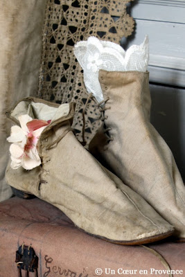 Old pair of boots decorated with a piece of lace and a flower fabric