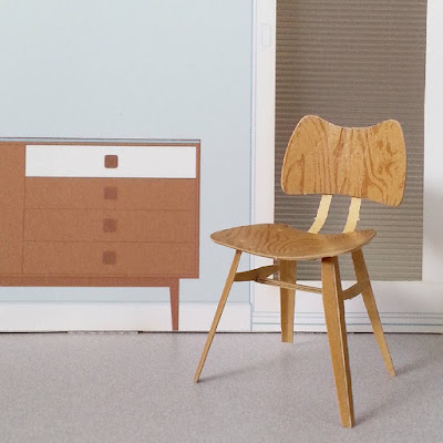 Completed cardboard model of a 1958 Ercol butterfly chair, in a printed room setting.