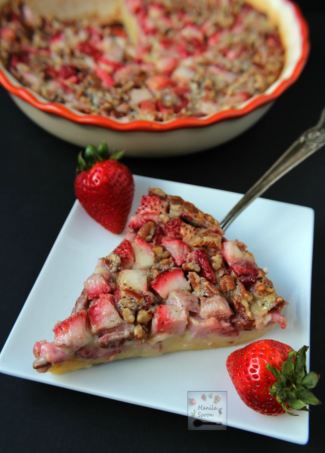 This delicious tart is unbelievably easy to make! Studded with the juiciest strawberries and crunchy pecans and then baked in a sweet vanilla custard batter it's the perfect summer dessert - Strawberry and Pecan Clafoutis | manilaspoon.com