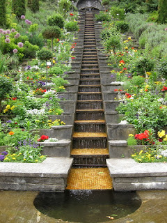 Stair-step waterfall bordered by flowers, Mainau, Germany