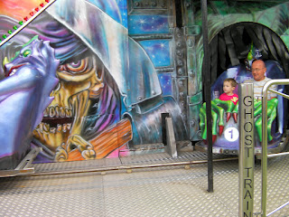 father and son on ghost train at the funfair