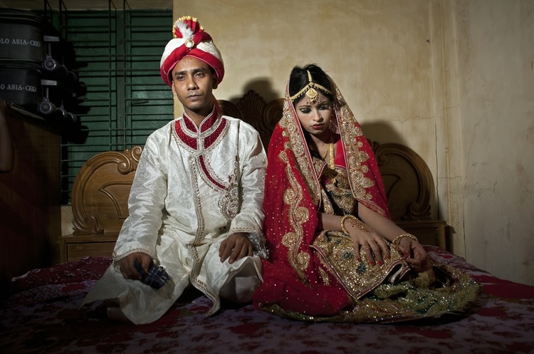 70 Of The Most Touching Photos Taken In 2015 - Mohammad Hasamur Rahman, 32, sits with this new bride, 15-year-old Nasoin Akhter, in Manikganj, Bangladesh. Photographer Allison Joyce described her as the 