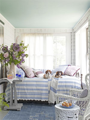 This screened in porch is a cozy hide-away with a plush daybed and some furry friends to cuddle with