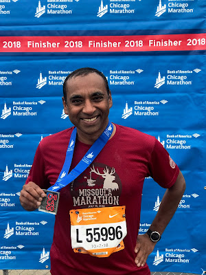 Shyam Biswal holding a finisher's medal at the 2018 Chicago Marathon