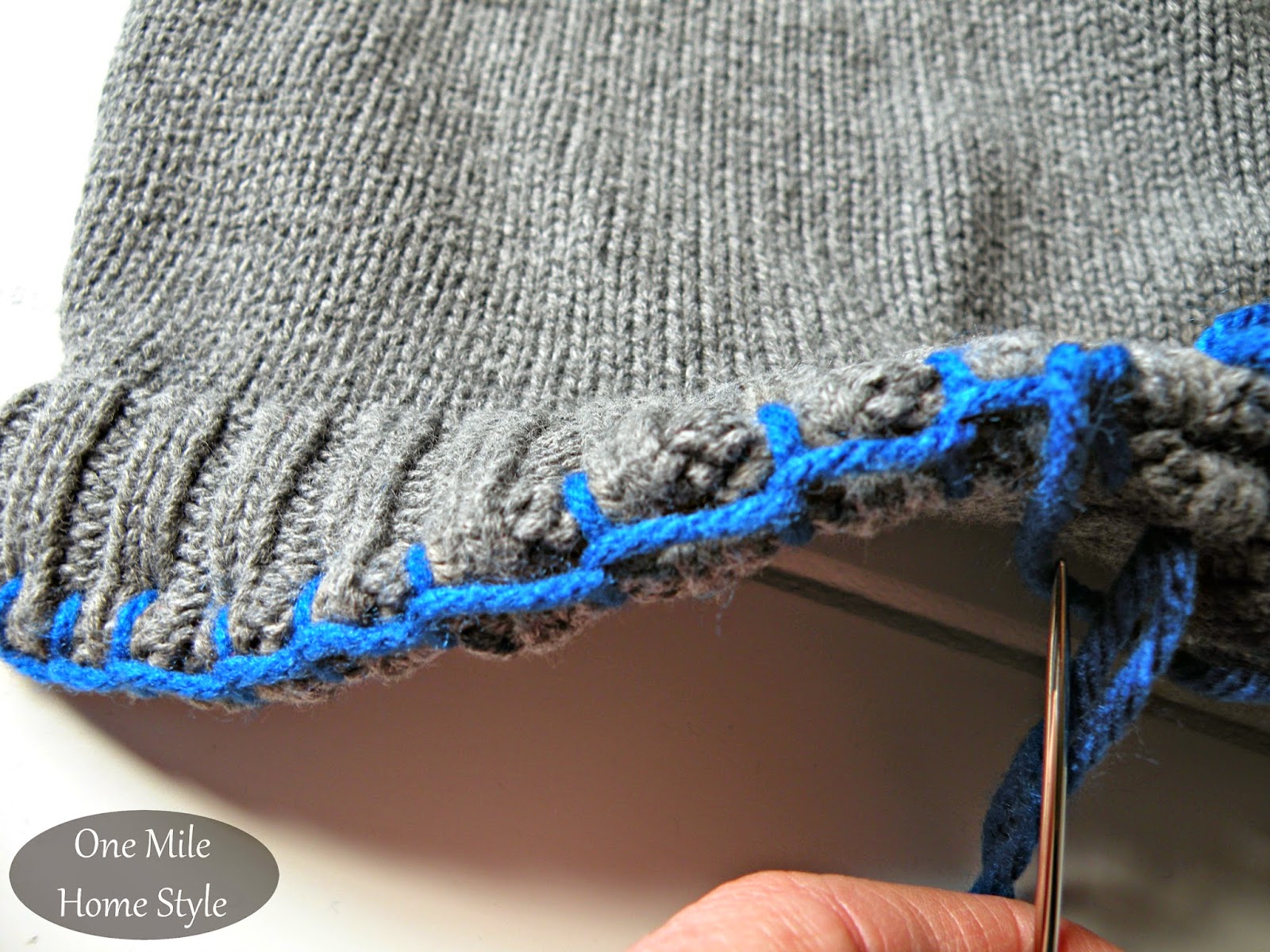 Accent color blanket stitch on DIY a sweater pillow