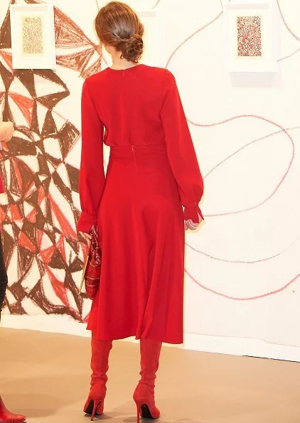 Queen Letizia carried Carolina Herrera Animal Print Clutch Bag and she wore Magrit Boots, red skirt and red blouse