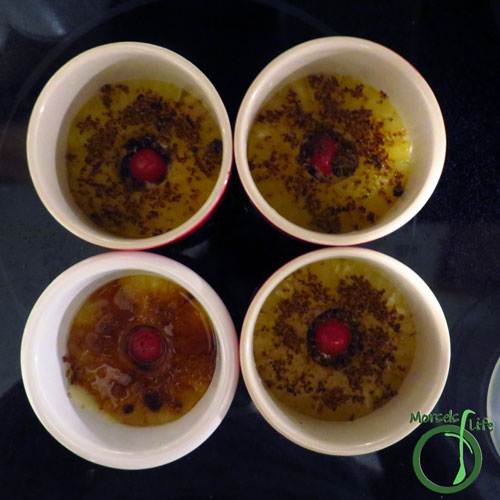 Morsels of Life - Mini Pineapple Upside Down Cake Step 3 - Place one pineapple slice and one maraschino cherry in each ramekin. Sprinkle with brown sugar.