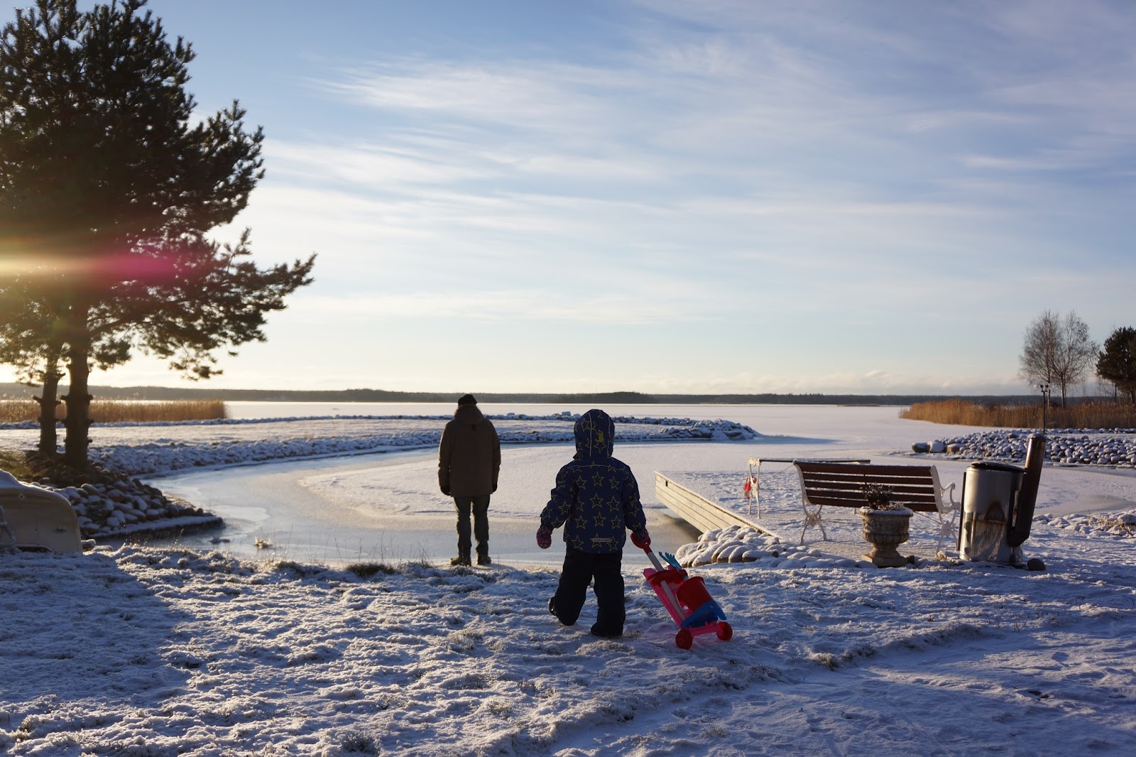 father and daughter walking on a frozen beach