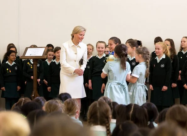 The Countess of Wessex wore Prada Gabardine wool jacket, skirt and suede pointtoe pumps. Sophie Habsburg clutch bag. Gold hoop earrings. Skagen Ladies watch