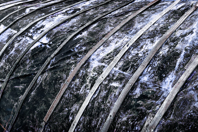 tar covered boat hull shed on Holy Island, Northumberland by Martyn Ferry Photography