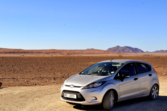 Car in desert landscape