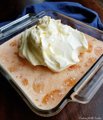 creamy jello and orange layer set with cream layer plopped on top