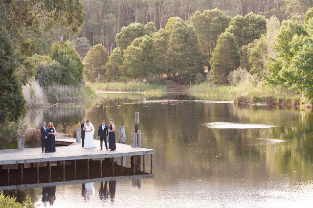 Photo showing bridal party on a pier by a lake in an Australian bush setting