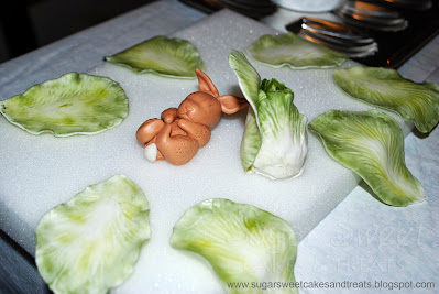 Process of making individual lettuce leaves out of fondant, dusted in petal dusts.