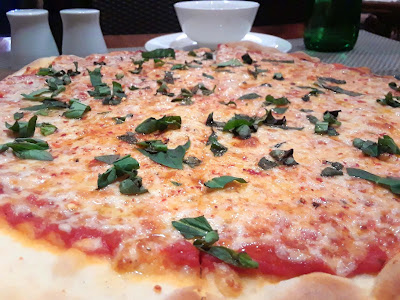 Neopolitan pizza with tomato sauce, cheese and basil