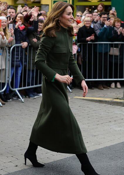 Kate Middleton wore a green midi dress by Suzannah. Alexander McQueen khaki long coat and Jimmy Choo boots