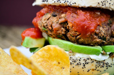 An easy but utterly delicious bean burger in a bun with salad, avocado and relish